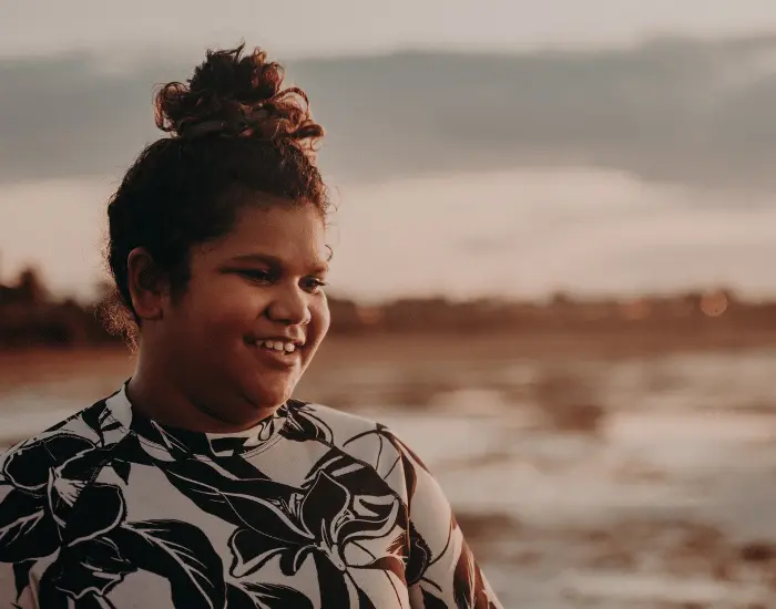 Happy Aboriginal woman smiling and looking past the camera